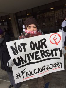 Protestors at KU wear NRA cloth around their mouths, symbolizing their voices being silenced by gun lobbyists. Source: Twitter.